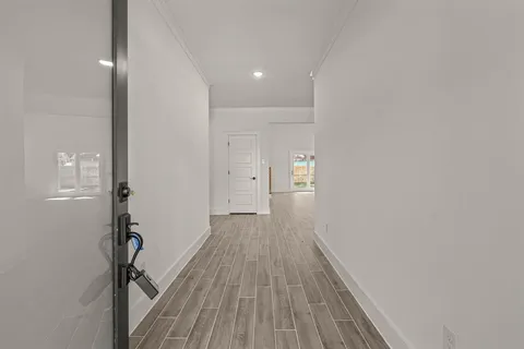 a view of a hallway with wooden floor