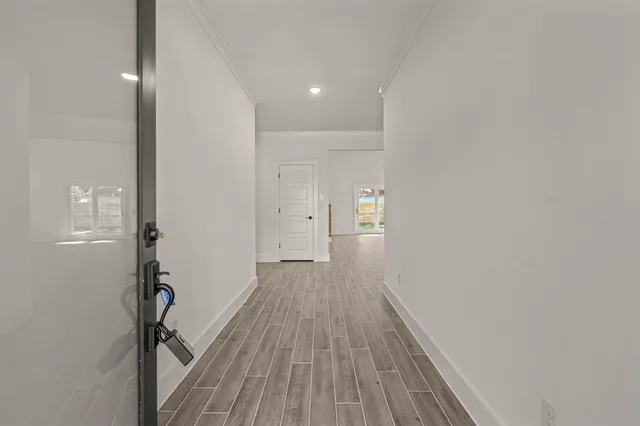 a view of a hallway with wooden floor
