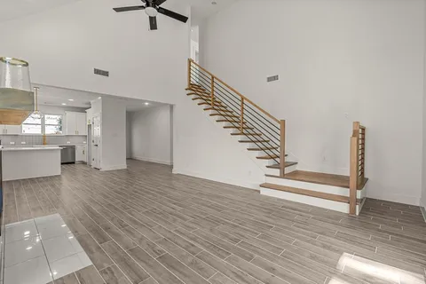 a view of entryway and kitchen with wooden floor