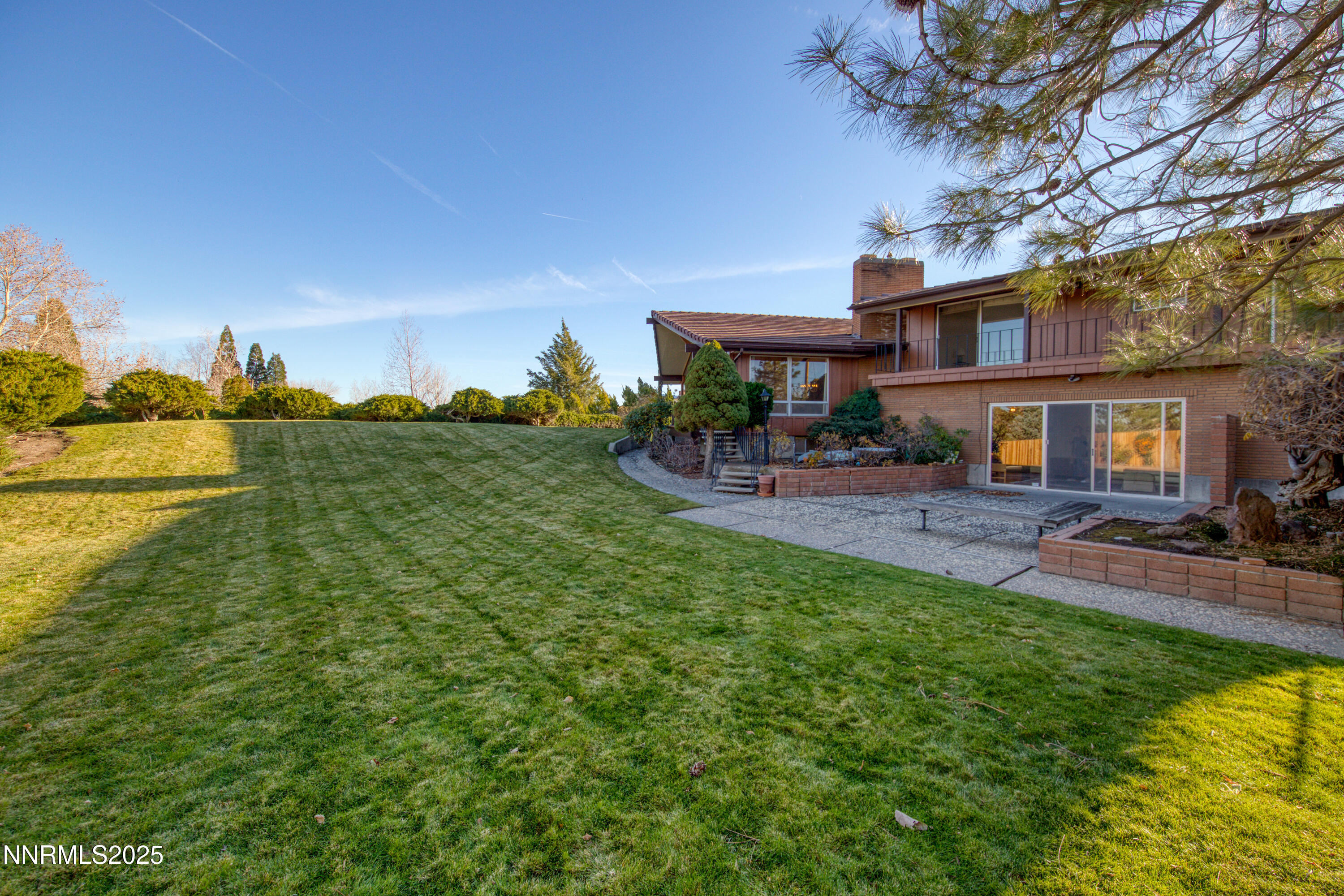 1965 Solari Drive Reno, NV 89509 - Photo 36 of 44 a view of a patio with table and chairs under an umbrella