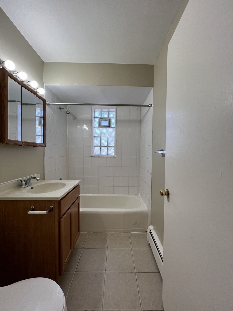 560 Princeton Street, Unit A2W Des Plaines, IL 60016 - Photo 11 of 15 a bathroom with a granite countertop sink toilet and shower