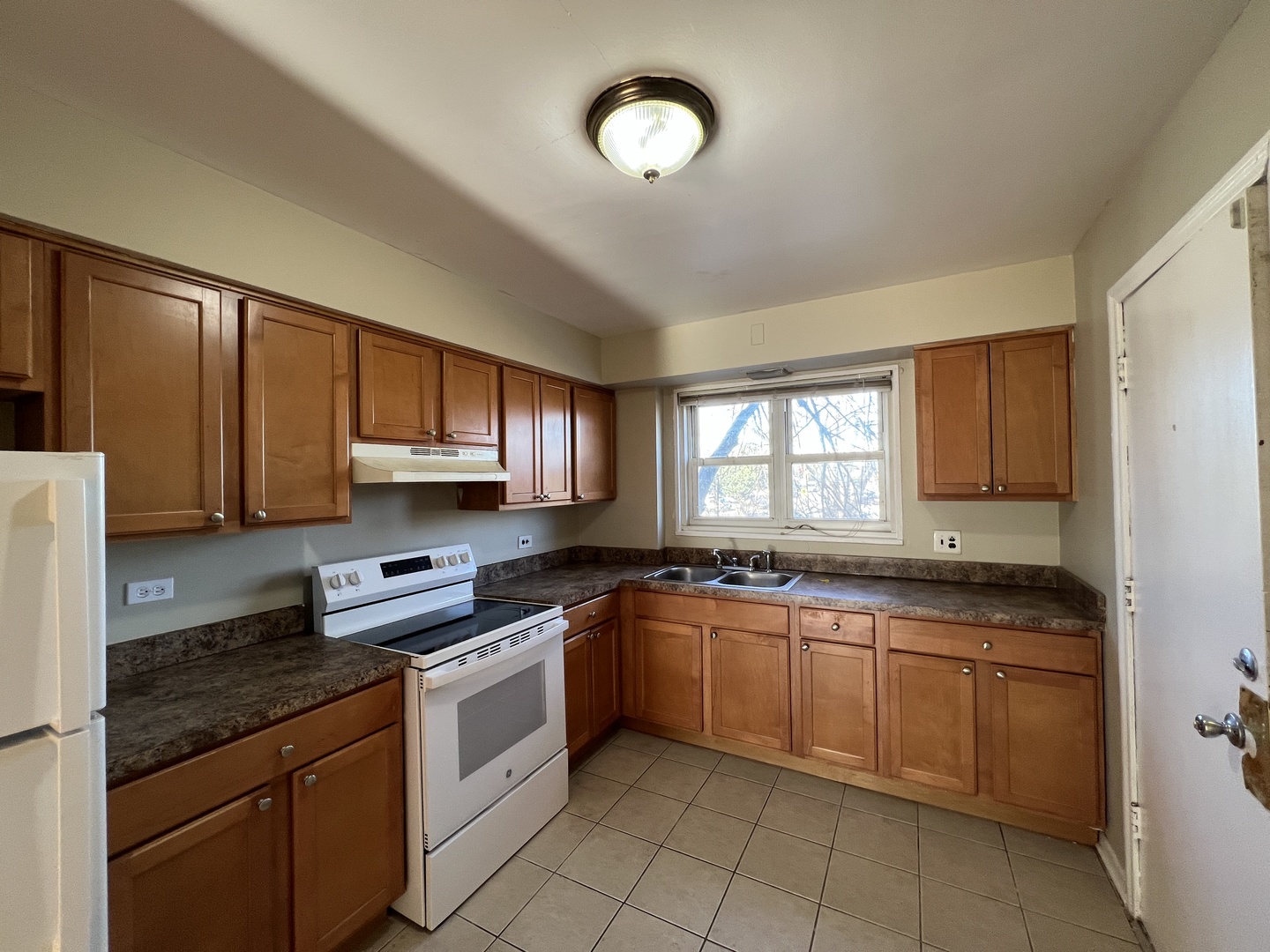 560 Princeton Street, Unit A2W Des Plaines, IL 60016 - Photo 3 of 15 a kitchen with stainless steel appliances granite countertop a stove sink and cabinets