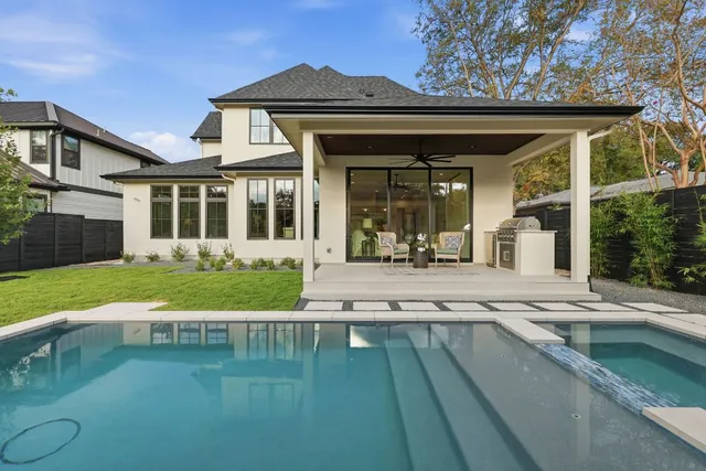 a front view of a house with a yard and trees