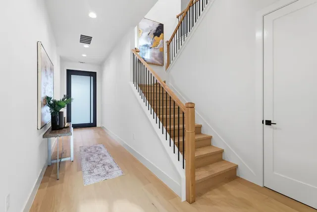 a view of entryway and hall with wooden floor