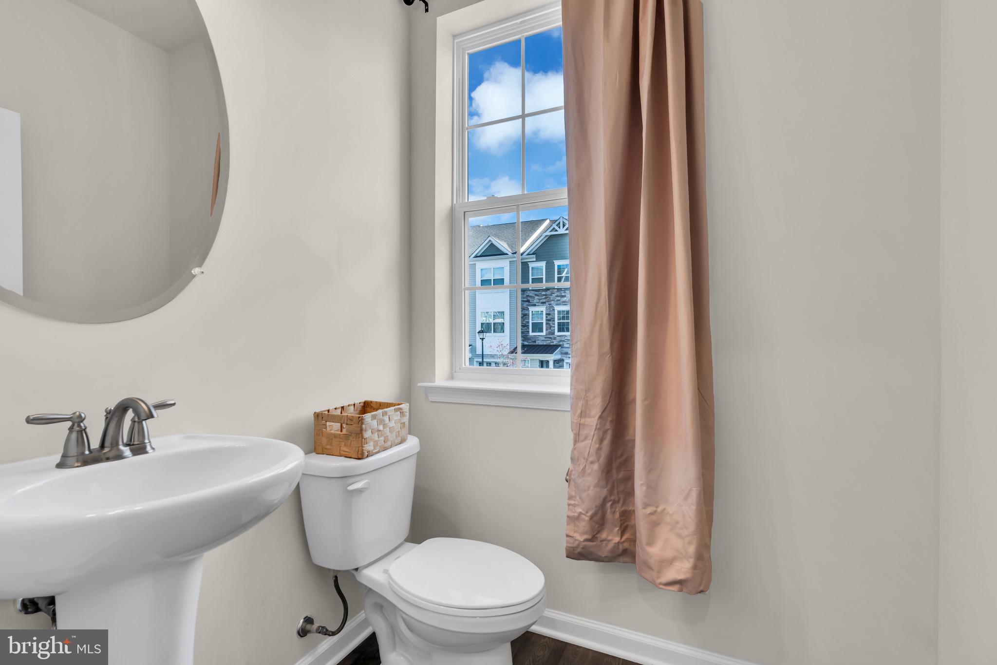 504 East International Road Monroe Township, NJ 08831 - Photo 12 of 37 a white toilet sitting next to a bathroom sink