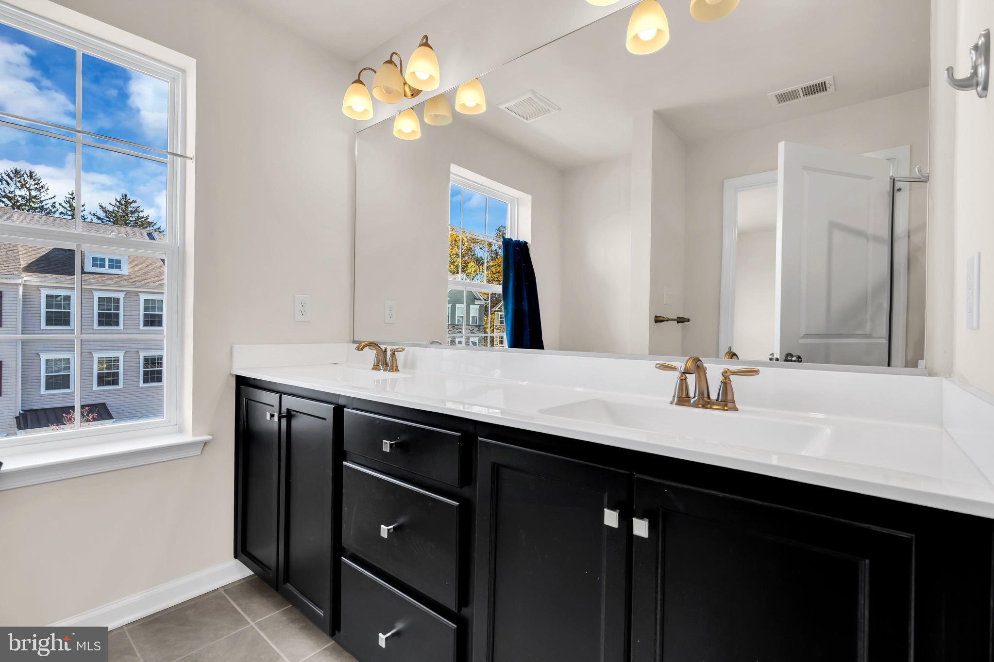 504 East International Road Monroe Township, NJ 08831 - Photo 22 of 37 a bathroom with a sink double vanity and a mirror