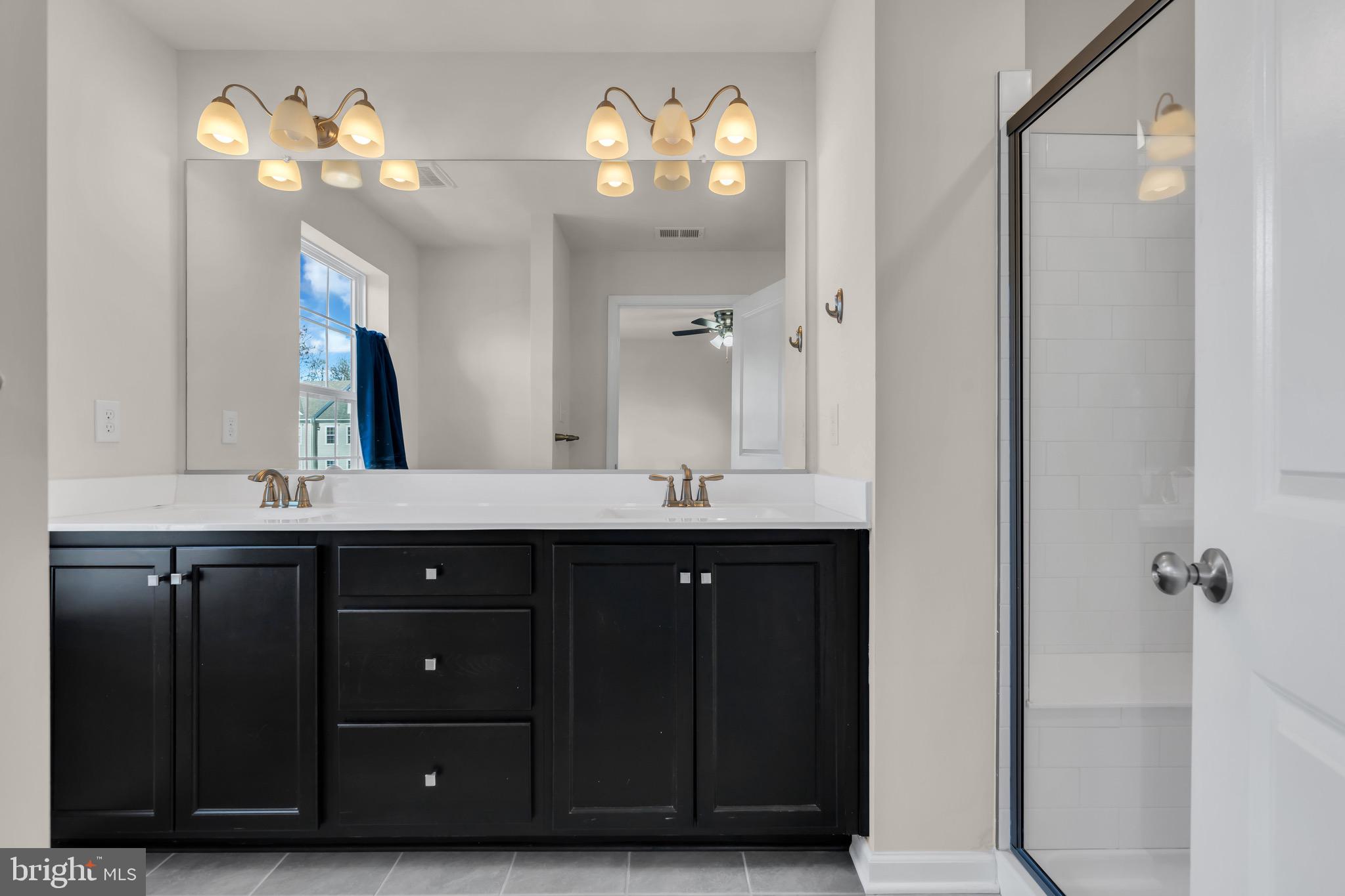 504 East International Road Monroe Township, NJ 08831 - Photo 23 of 37 a bathroom with a sink vanity and a mirror