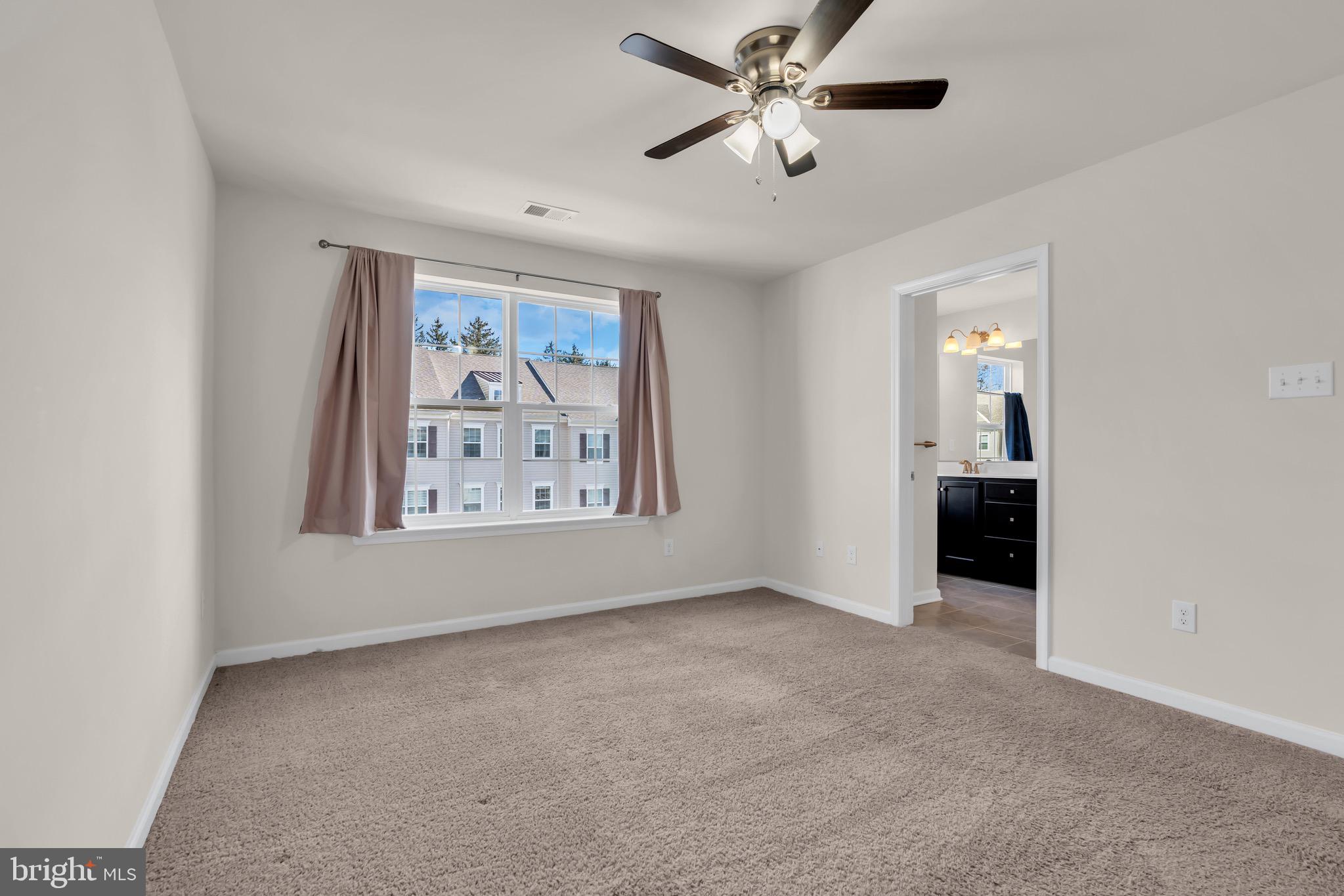 504 East International Road Monroe Township, NJ 08831 - Photo 24 of 37 an empty room with windows and ceiling fan
