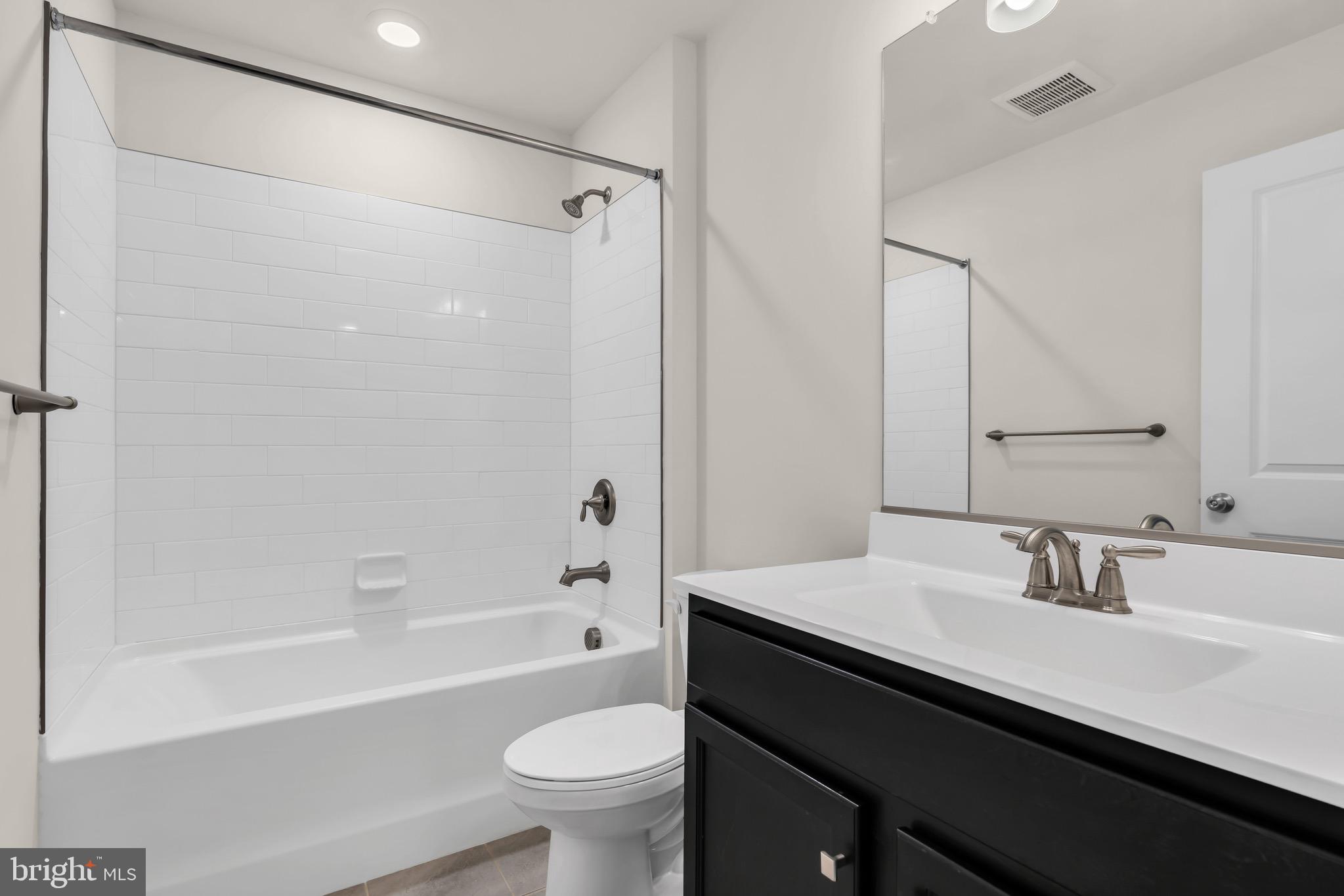 504 East International Road Monroe Township, NJ 08831 - Photo 27 of 37 a bathroom with a bathtub sink vanity mirror and toilet