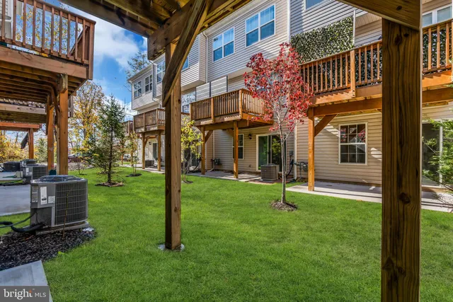 a view of backyard with a deck and a garden