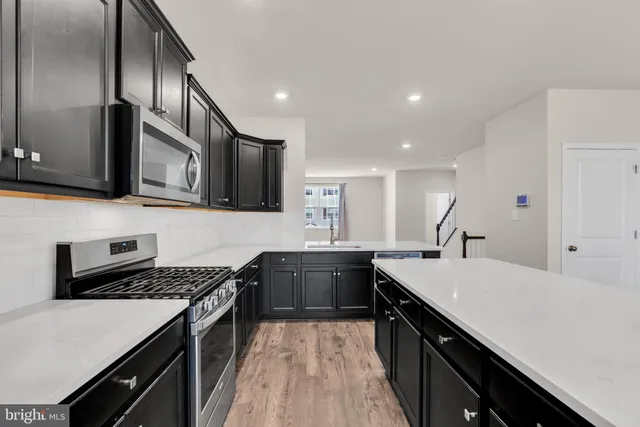 a kitchen with a stove sink and cabinets
