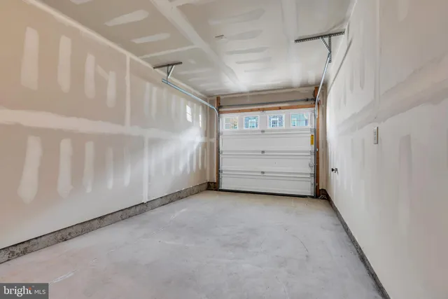 a view of staircase with wooden floor and white walls