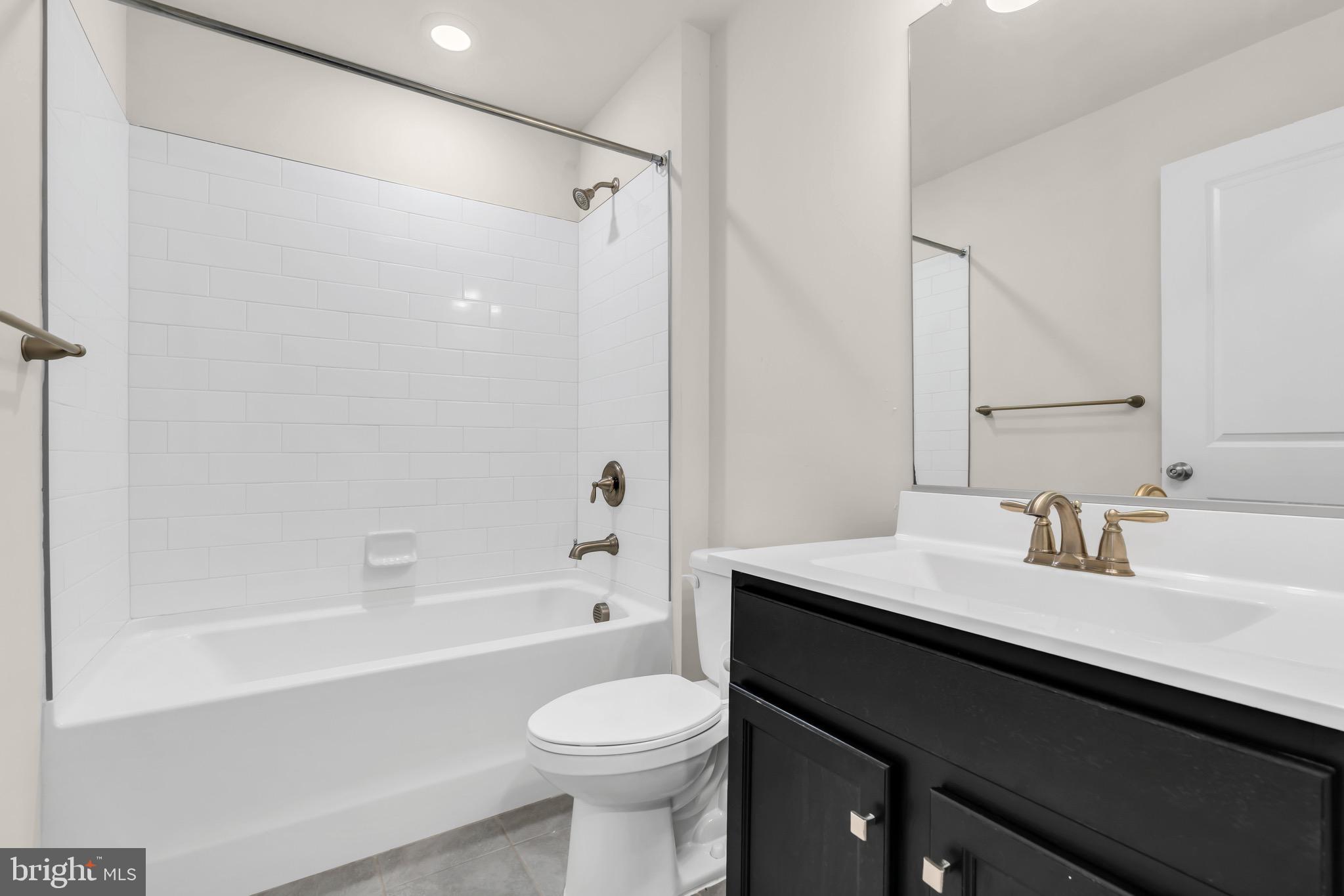 504 East International Road Monroe Township, NJ 08831 - Photo 6 of 37 a bathroom with a sink a toilet a mirror and shower