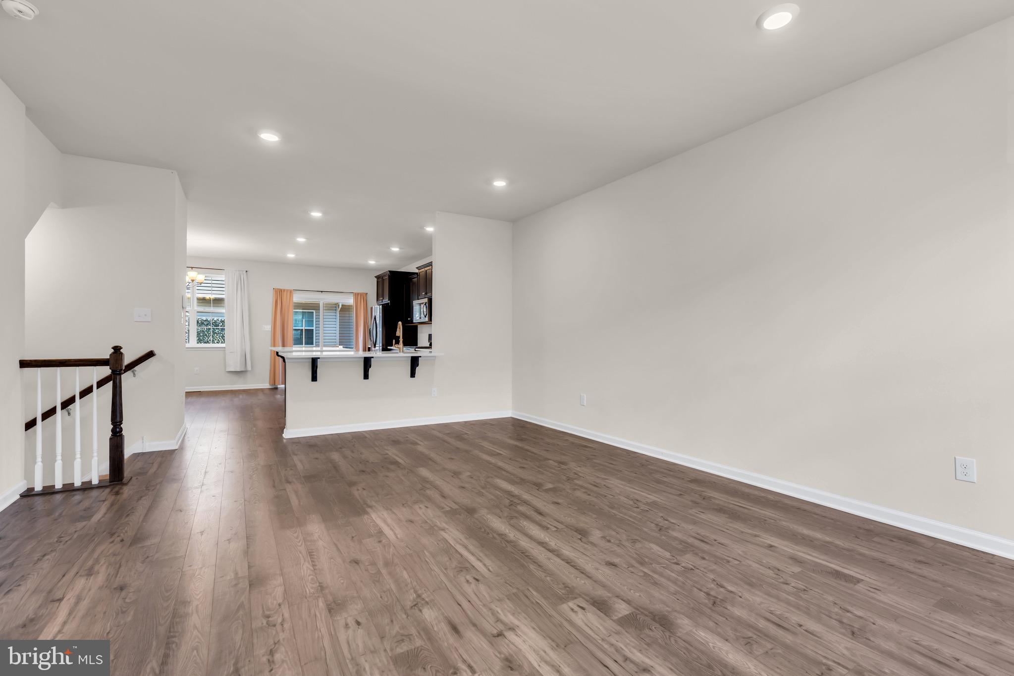 504 East International Road Monroe Township, NJ 08831 - Photo 8 of 37 a view of a big room with wooden floor and a kitchen