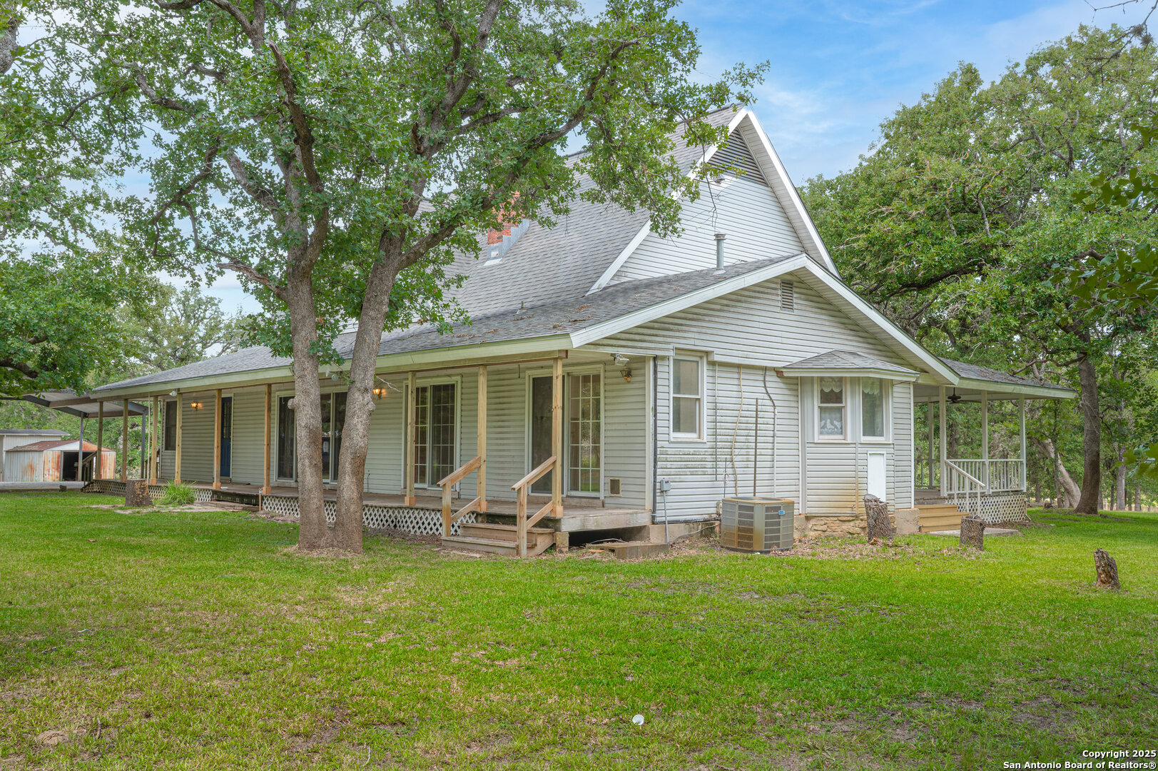 2981 Vivroux Ranch Road Seguin, TX 78155 - Photo 5 of 50 a front view of house with a garden and trees