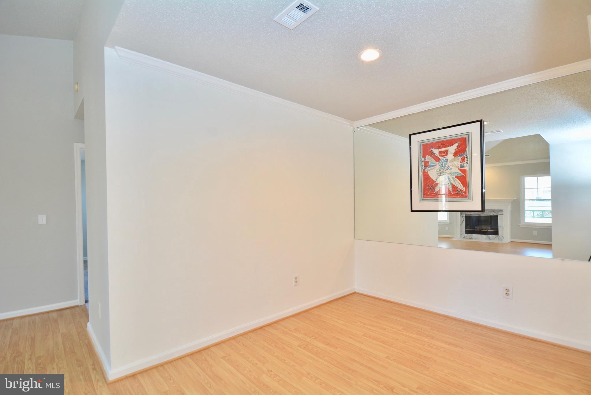 12000 Taliesin Place, Unit 36 Reston, VA 20190 - Photo 11 of 36 an empty room with a painting on the wall