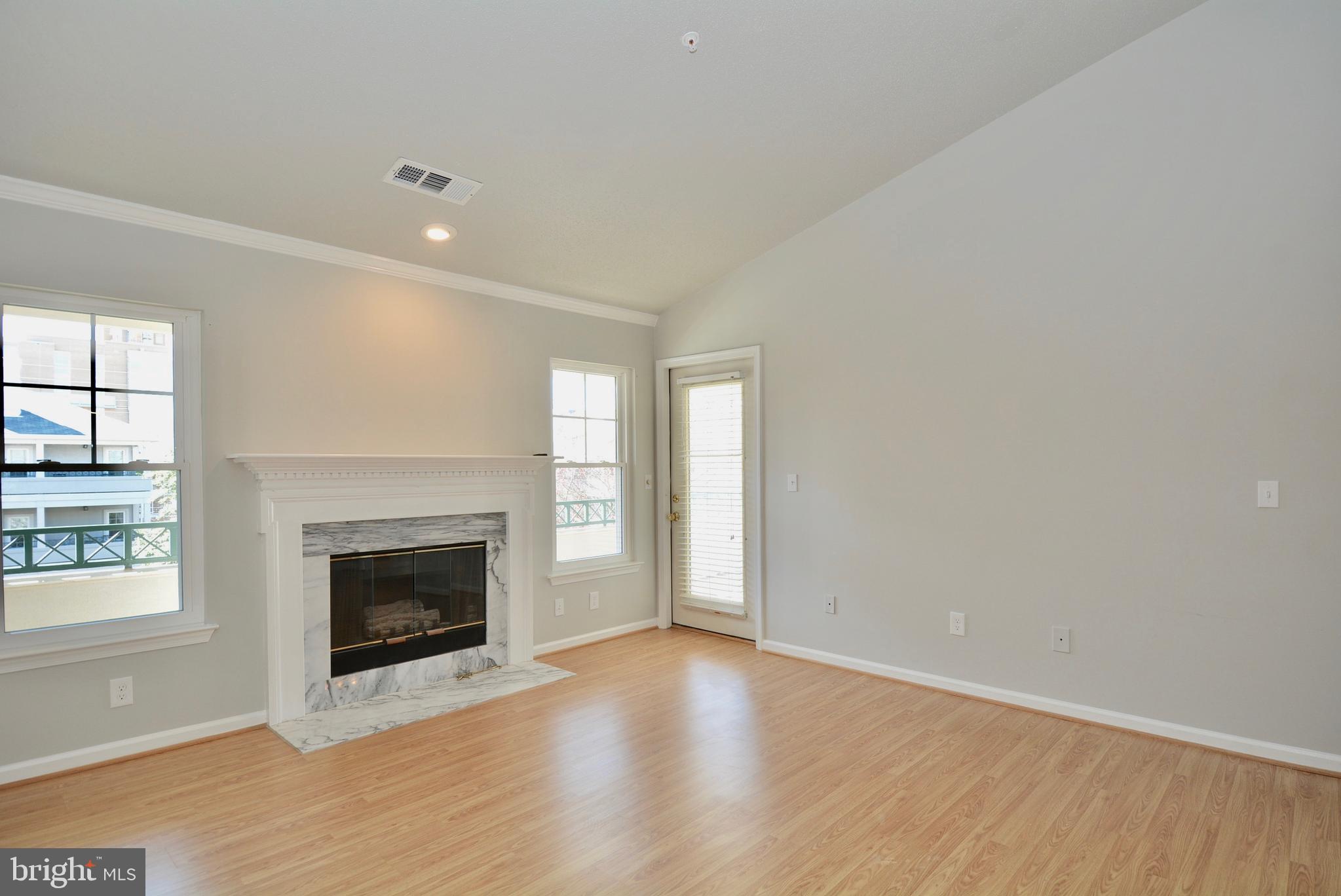 12000 Taliesin Place, Unit 36 Reston, VA 20190 - Photo 14 of 36 an empty room with windows and fireplace