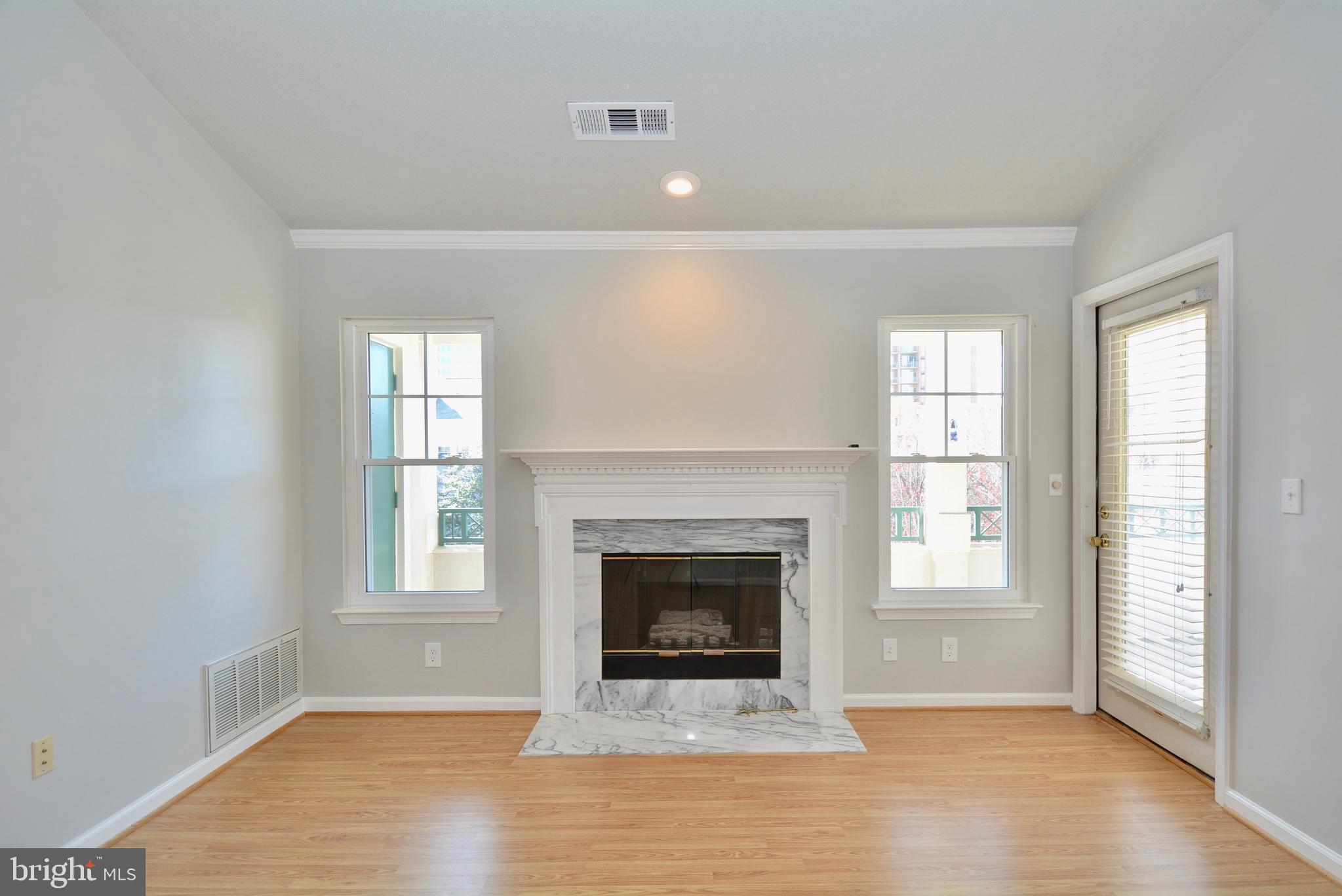12000 Taliesin Place, Unit 36 Reston, VA 20190 - Photo 15 of 36 an empty room with windows and fireplace