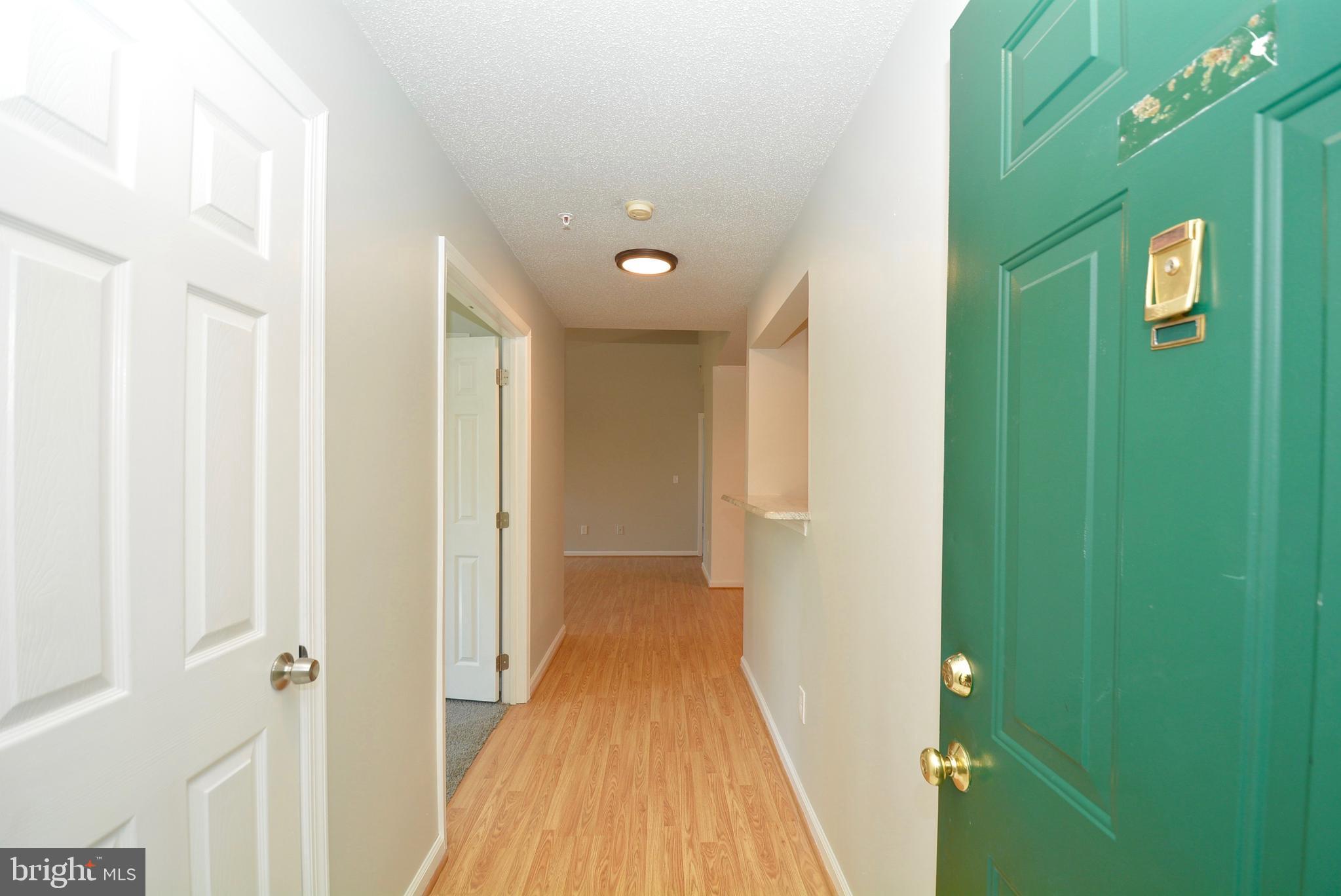 12000 Taliesin Place, Unit 36 Reston, VA 20190 - Photo 3 of 36 a view of a hallway with wooden floor