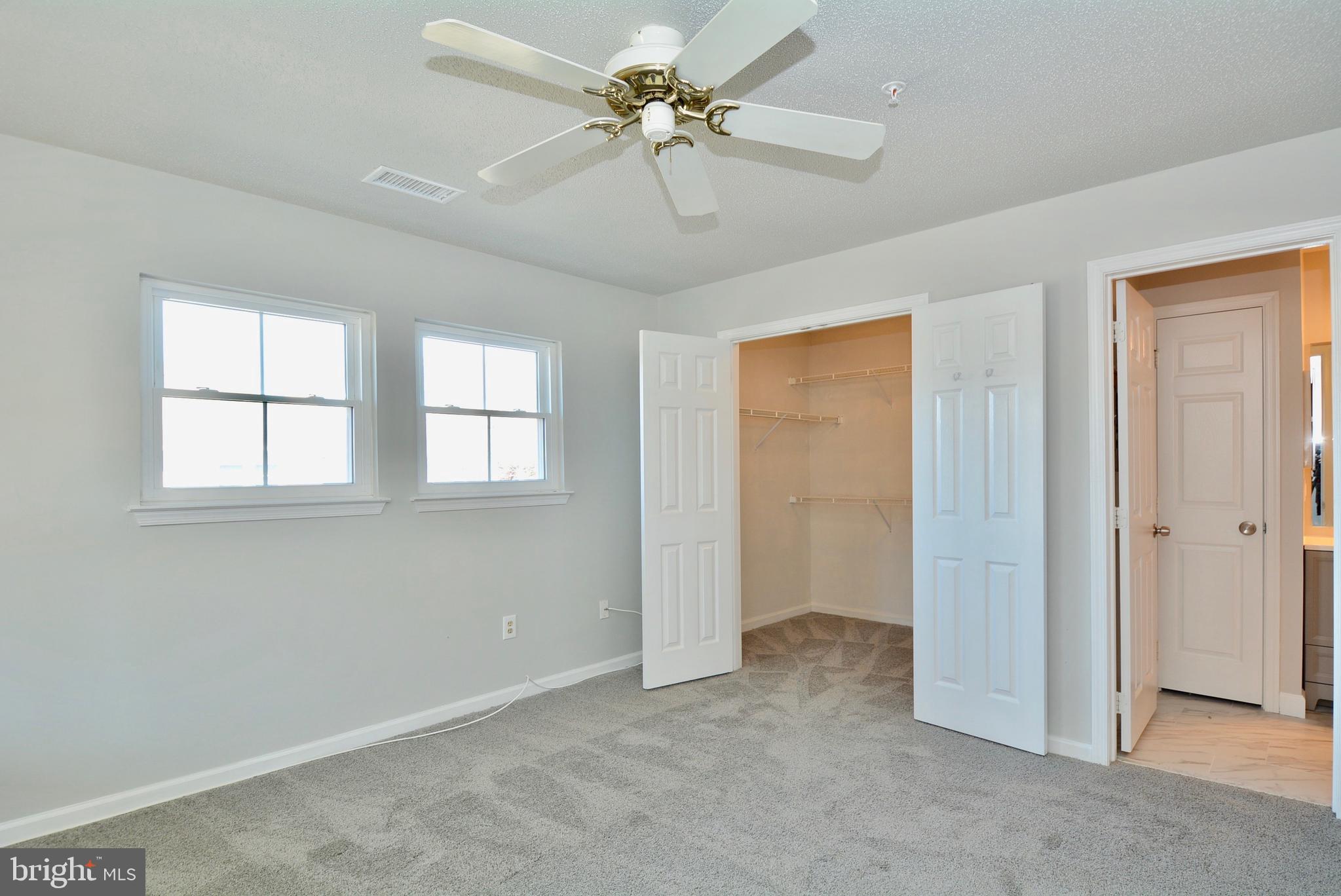 12000 Taliesin Place, Unit 36 Reston, VA 20190 - Photo 22 of 36 a view of an empty room with a ceiling fan and a window