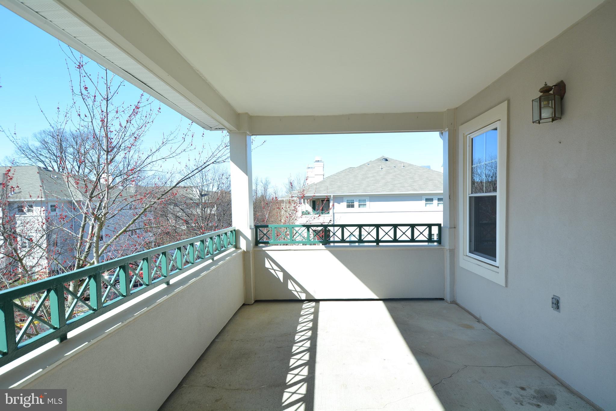 12000 Taliesin Place, Unit 36 Reston, VA 20190 - Photo 30 of 36 a view of balcony with a couple of car parked