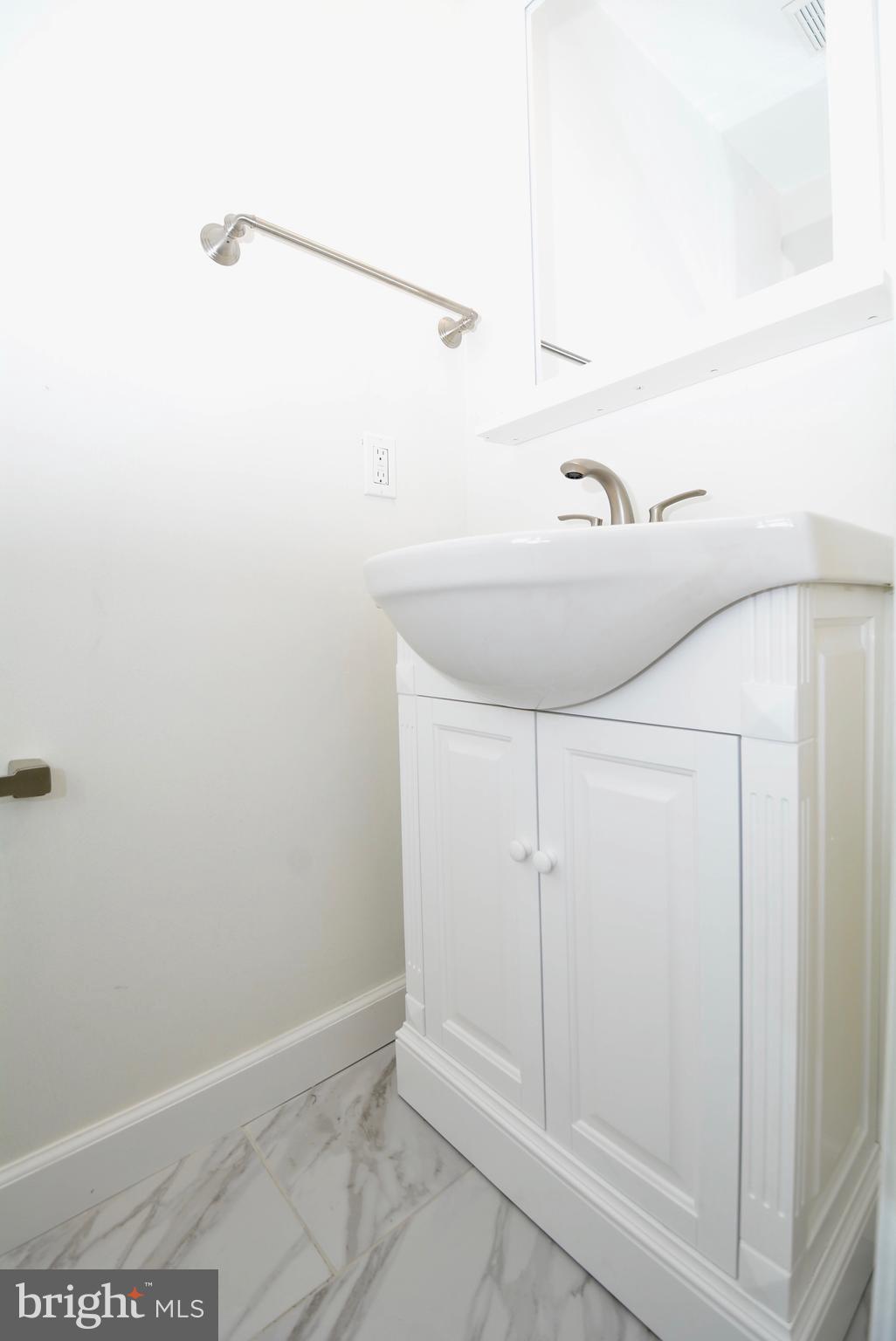 12000 Taliesin Place, Unit 36 Reston, VA 20190 - Photo 32 of 36 a bathroom with a sink and shower