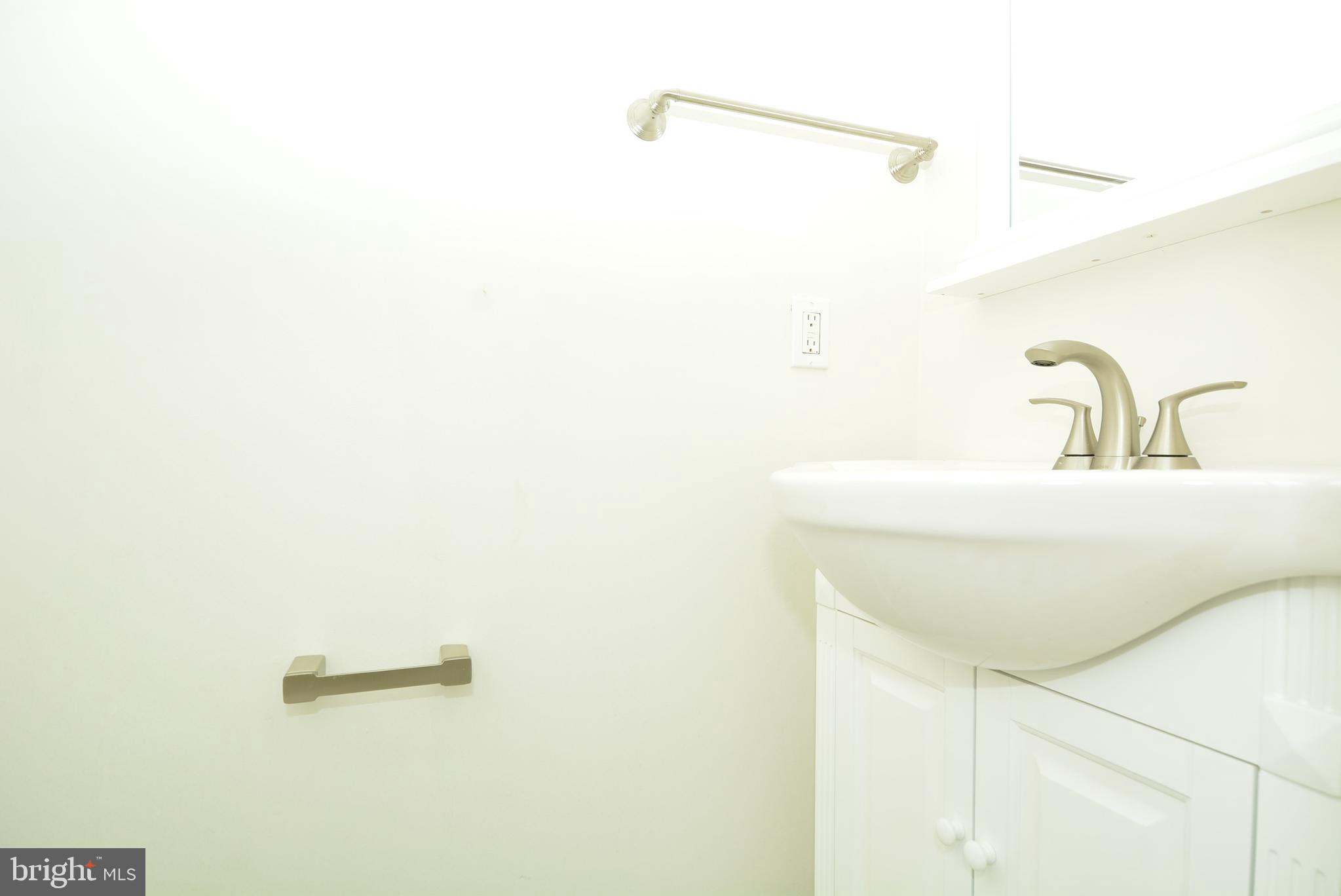12000 Taliesin Place, Unit 36 Reston, VA 20190 - Photo 33 of 36 a bathroom with a sink and mirror