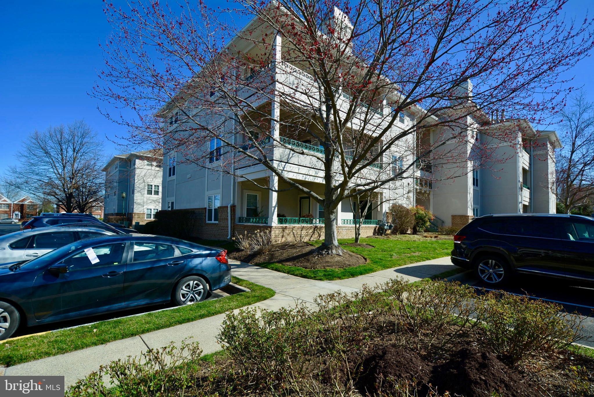 12000 Taliesin Place, Unit 36 Reston, VA 20190 - Photo 36 of 36 a view of a yard with cars parked in front of a house