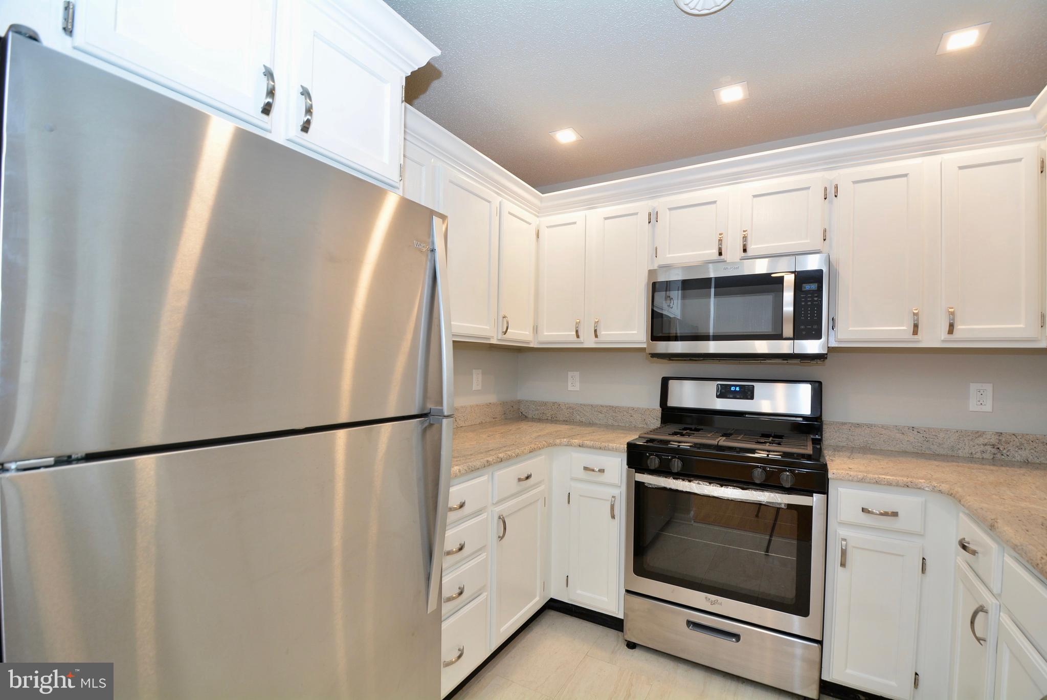 12000 Taliesin Place, Unit 36 Reston, VA 20190 - Photo 7 of 36 a white refrigerator freezer sitting in a kitchen