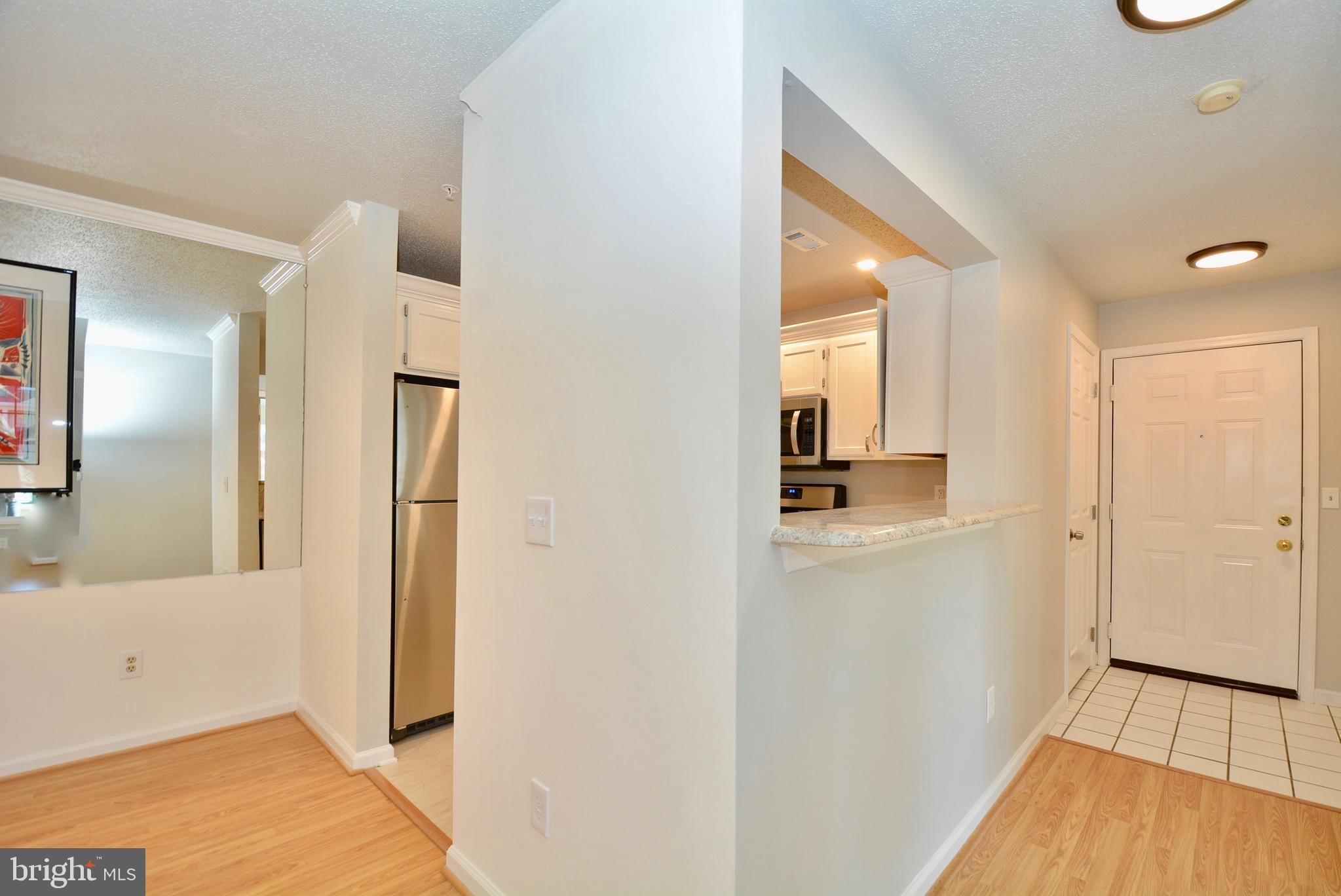 12000 Taliesin Place, Unit 36 Reston, VA 20190 - Photo 10 of 36 a view of a hallway with wooden floor and a bathroom