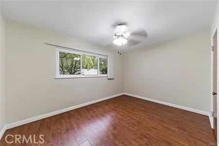 a view of a room with wooden floor and windows