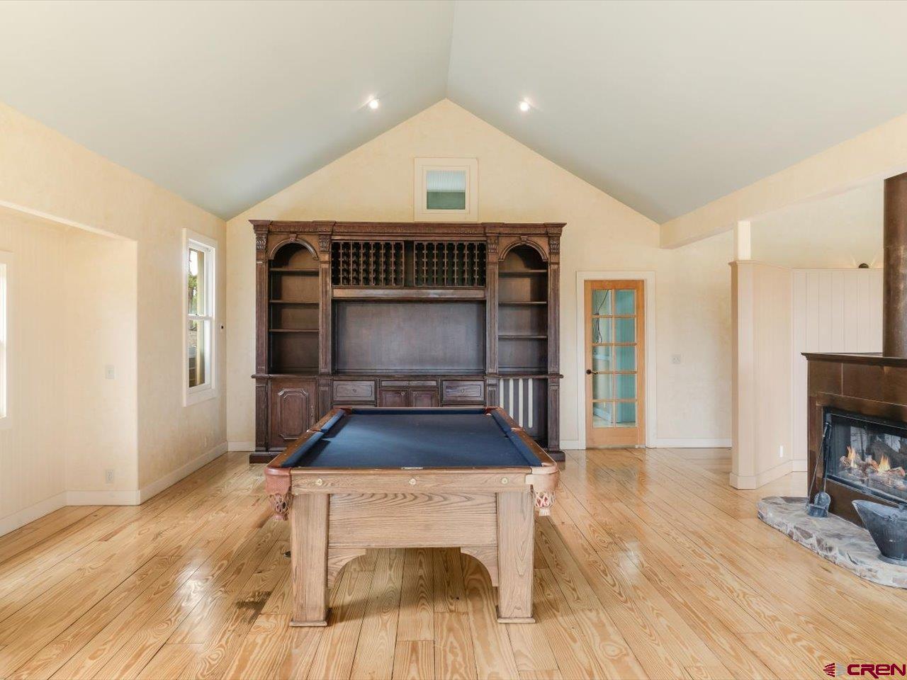 622 Bristlecone Drive Ridgway, CO 81432 - Photo 11 of 35 a living room with furniture a fireplace and a flat screen tv
