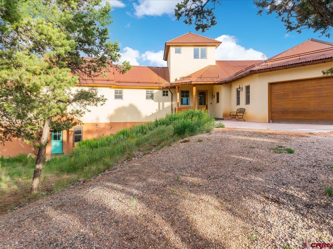 622 Bristlecone Drive Ridgway, CO 81432 - Photo 2 of 35 a front view of a house with a yard and a garage