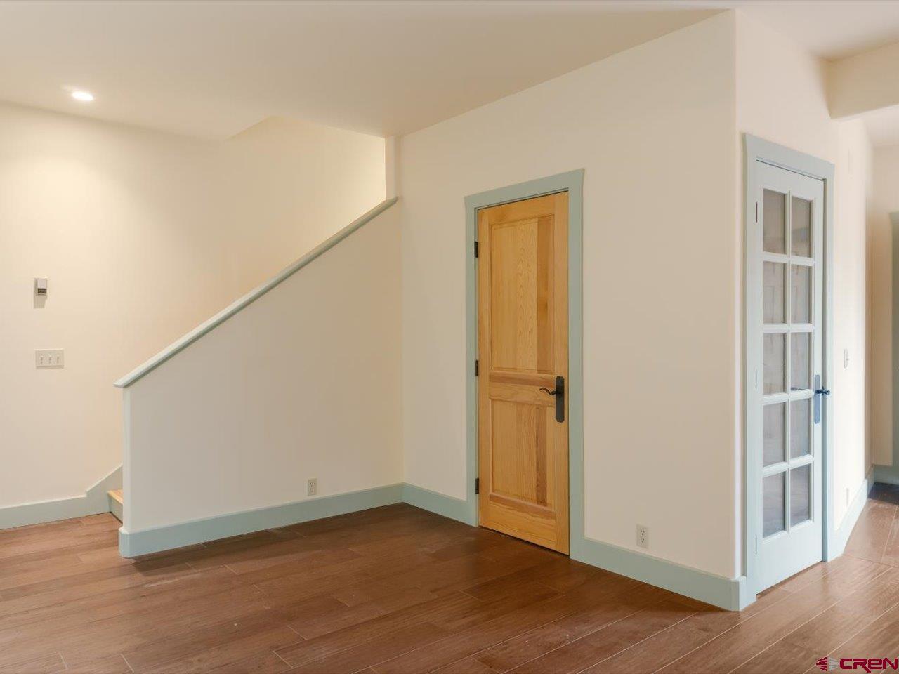 622 Bristlecone Drive Ridgway, CO 81432 - Photo 23 of 35 a view of an empty room with wooden floor and a window