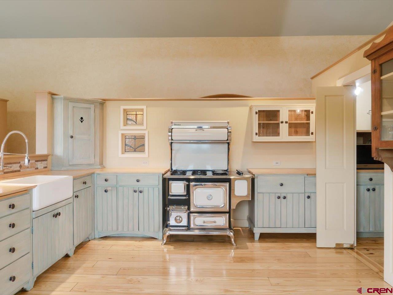622 Bristlecone Drive Ridgway, CO 81432 - Photo 7 of 35 a kitchen with stainless steel appliances a stove and white cabinets