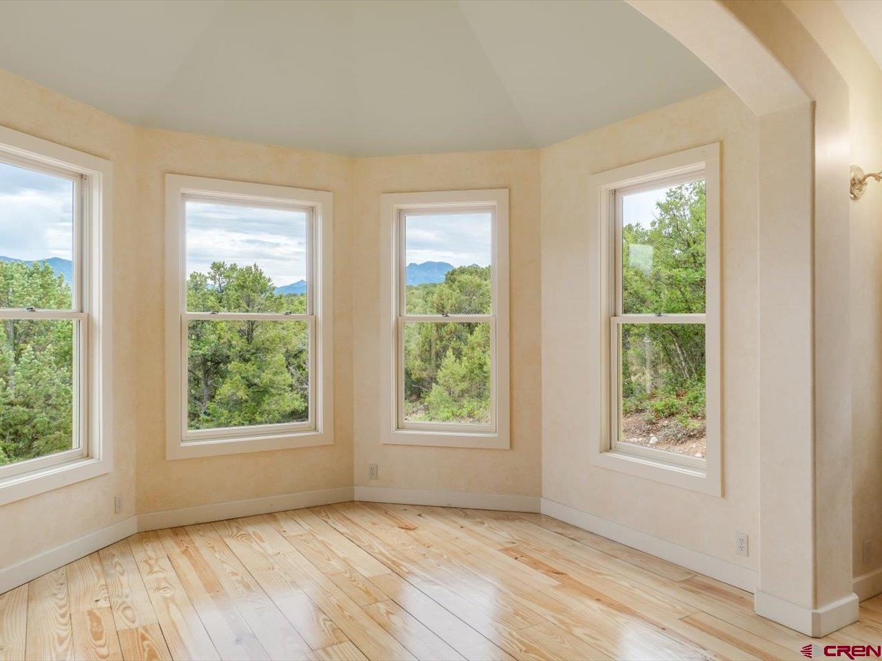 622 Bristlecone Drive Ridgway, CO 81432 - Photo 10 of 35 a view of an empty room with wooden floor and a window