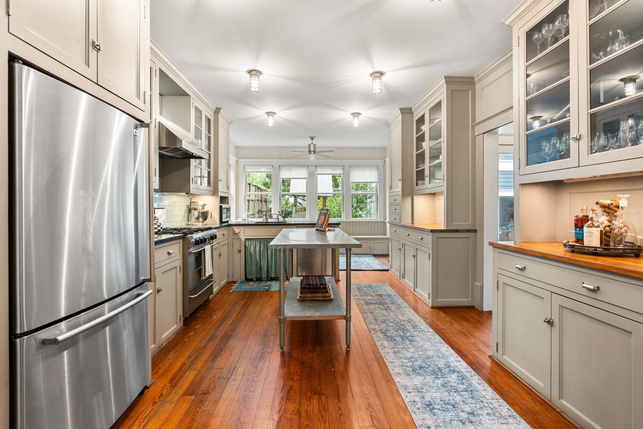 3012 Beauchamp Street Houston, TX 77009 - Photo 12 of 43 a kitchen with white cabinets and stainless steel appliances