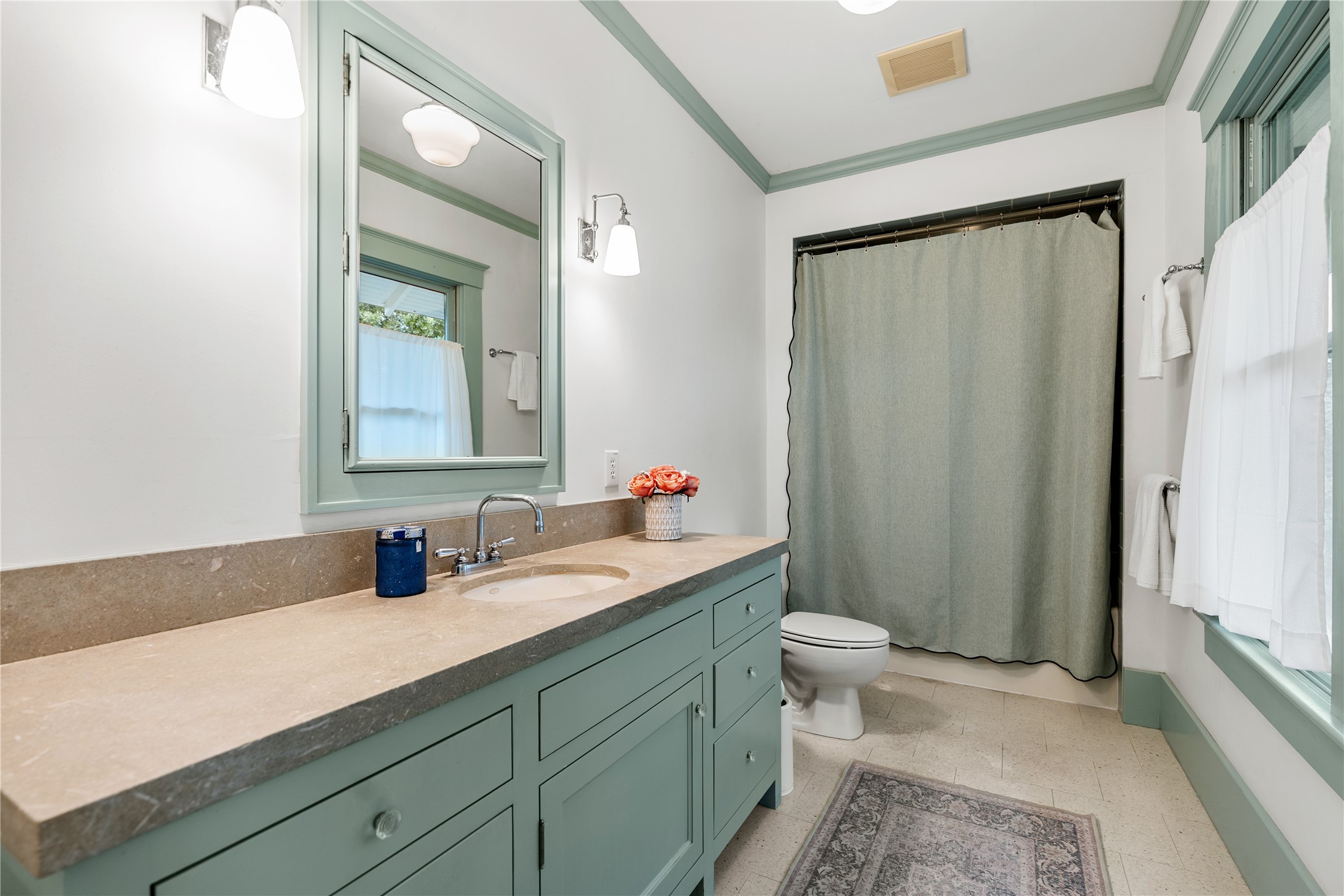 3012 Beauchamp Street Houston, TX 77009 - Photo 29 of 43 a bathroom with a sink a toilet a mirror and shower