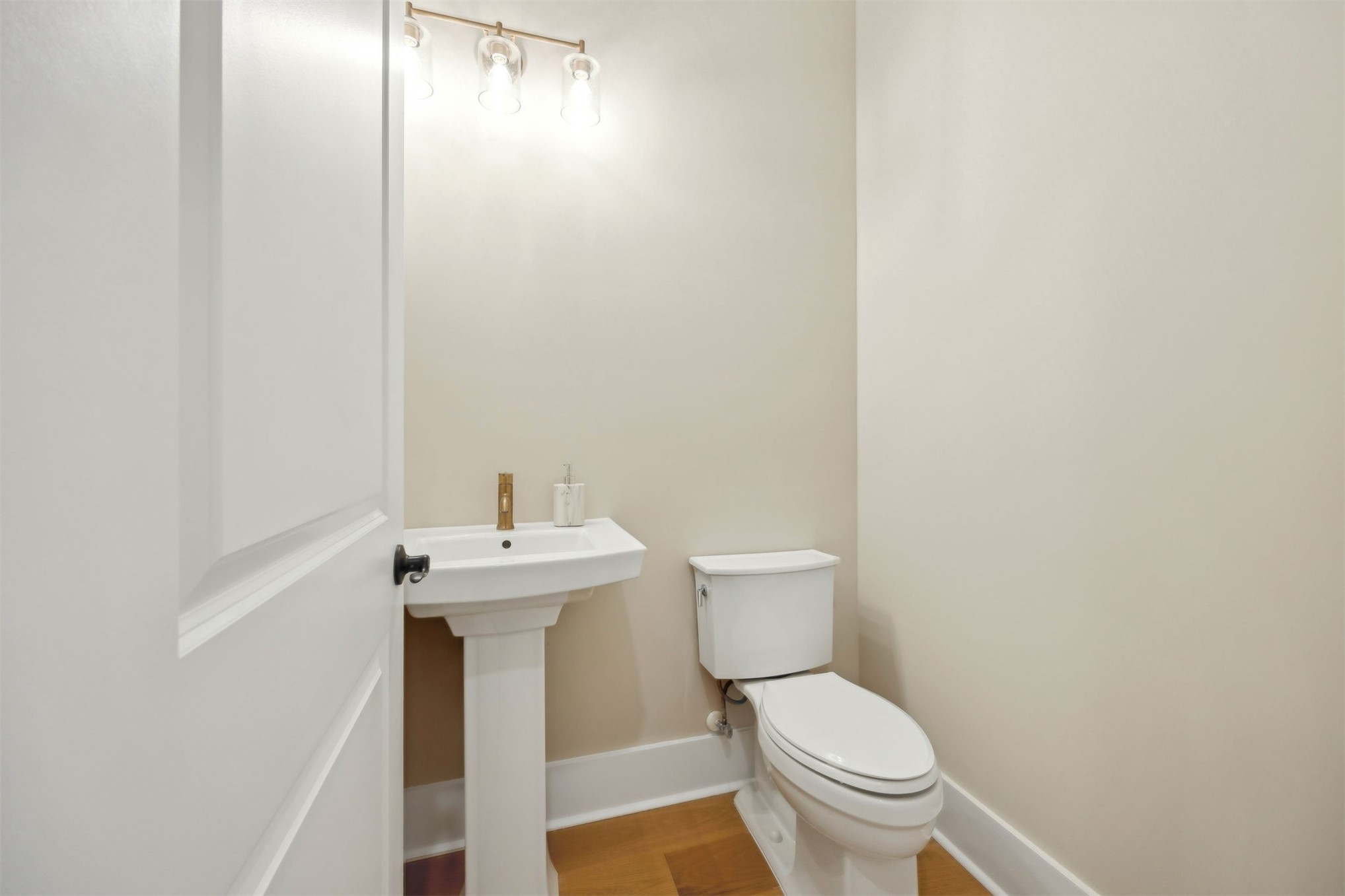 1111 White Street Fernandina Beach, FL 32034 - Photo 33 of 82 a white toilet sitting next to a white sink