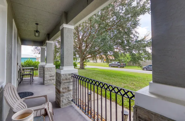a view of a porch with furniture and garden