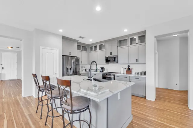 a view of kitchen with cabinets table and chairs