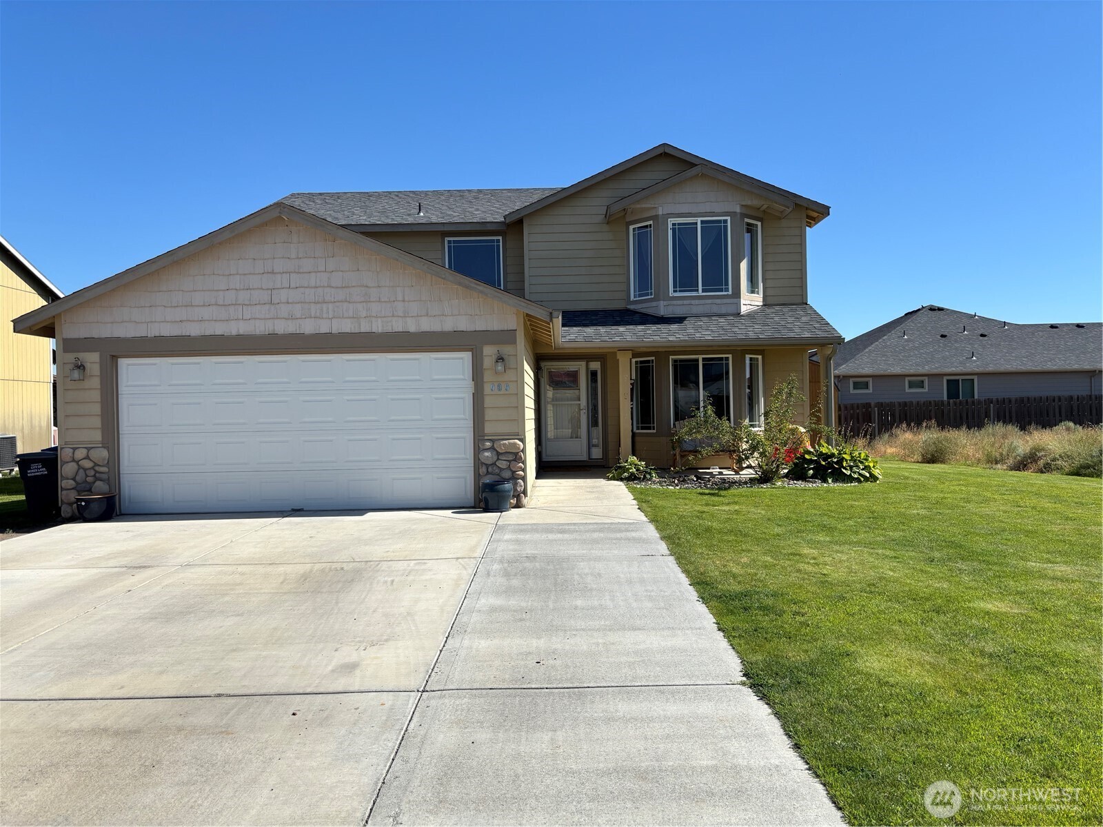 a front view of a house with a yard and garage