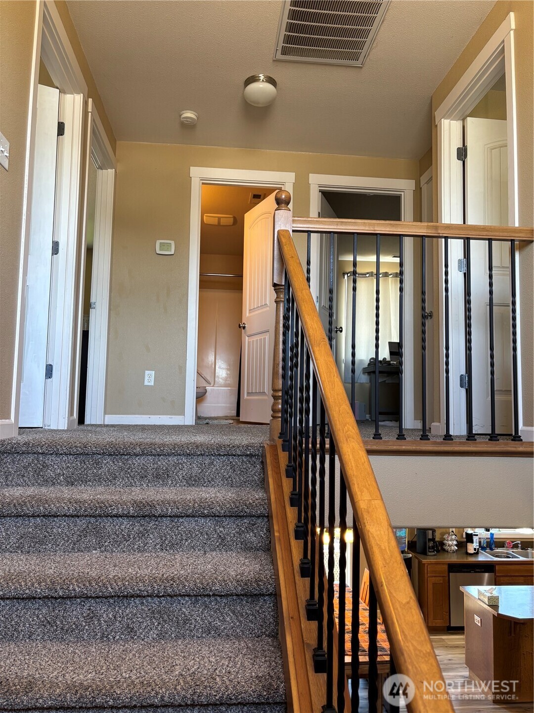 909 Polo Ridge Moses Lake, WA 98837 - Photo 17 of 27 a view of staircase with railing and white walls