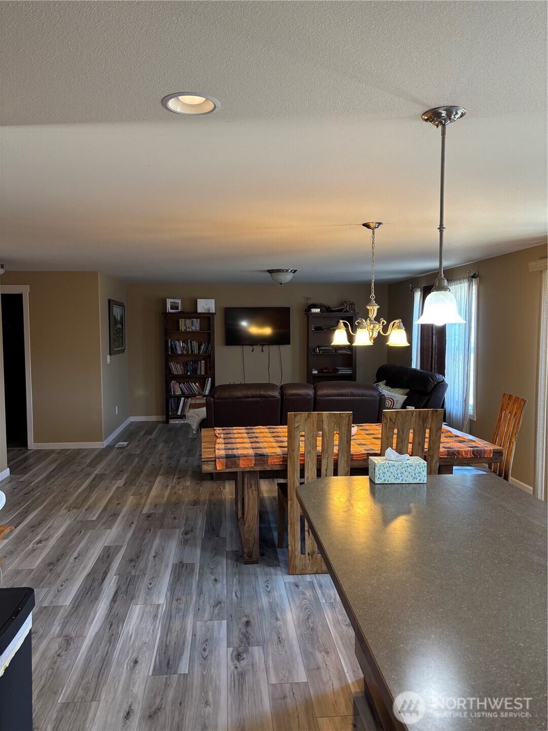 909 Polo Ridge Moses Lake, WA 98837 - Photo 19 of 27 a dining room with wooden floor a glass table and chairs