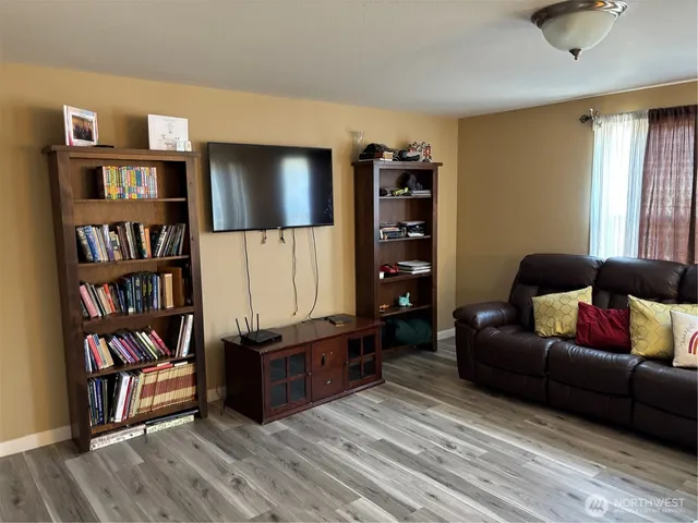 a living room with furniture and a book shelf