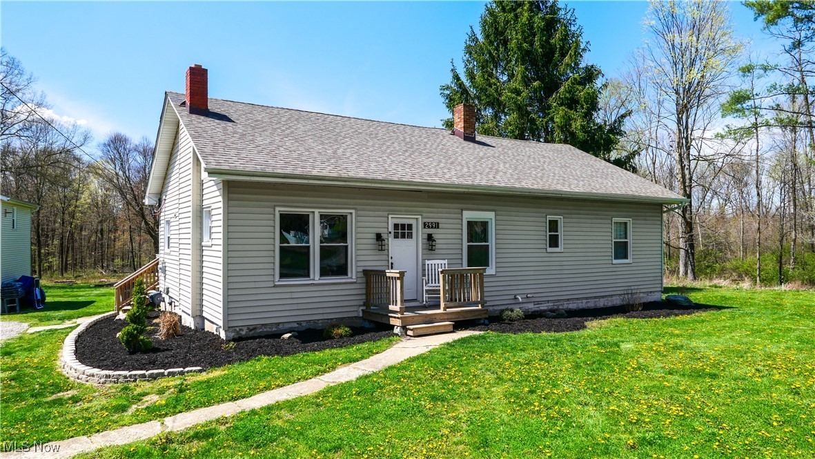 2991 Bushnell Campbell Road Fowler, OH 44418 - Photo 25 of 41 View of front of property featuring a front yard, roof with shingles, and a chimney