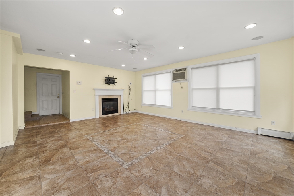 276 Oak Street Brockton, MA 02301 - Photo 13 of 42 an empty room with windows and fireplace