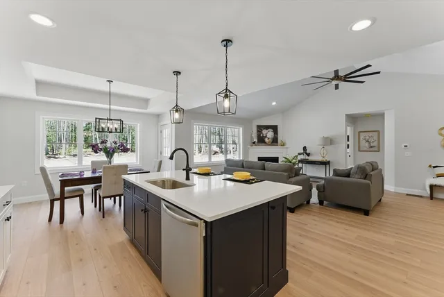 a kitchen with stainless steel appliances granite countertop stove a table and chairs