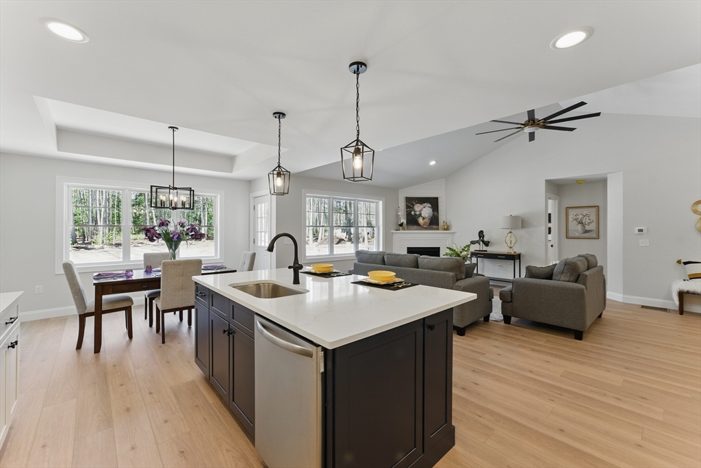 18 Nicols Way, Unit 18 Easthampton, MA 01027 - Photo 11 of 40 a kitchen with stainless steel appliances granite countertop stove a table and chairs