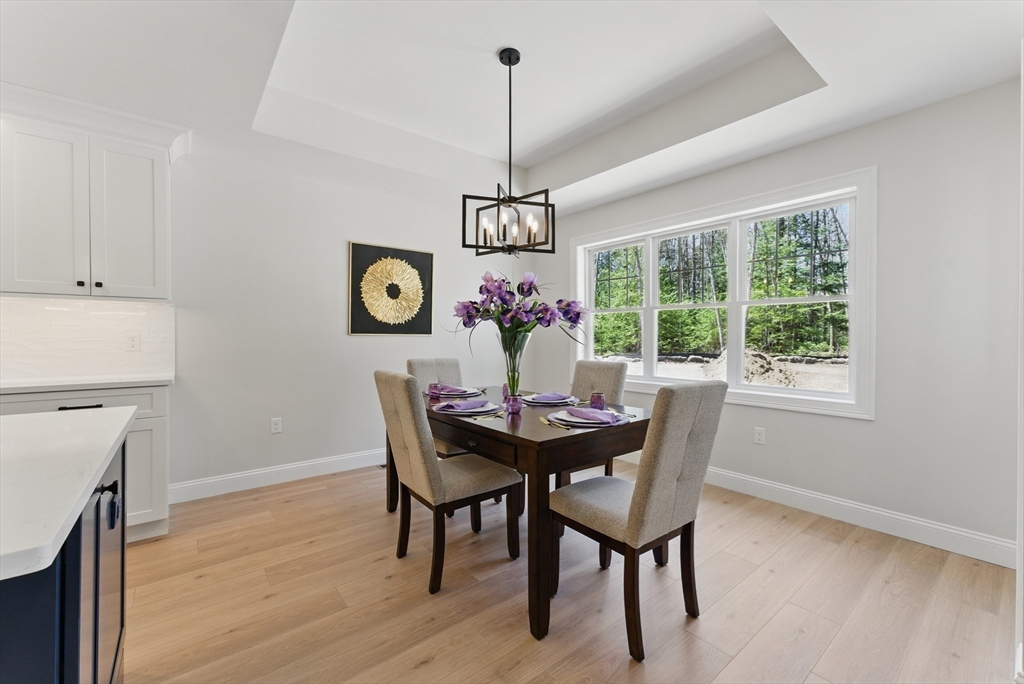 18 Nicols Way, Unit 18 Easthampton, MA 01027 - Photo 12 of 40 a view of a dining room with furniture window and wooden floor